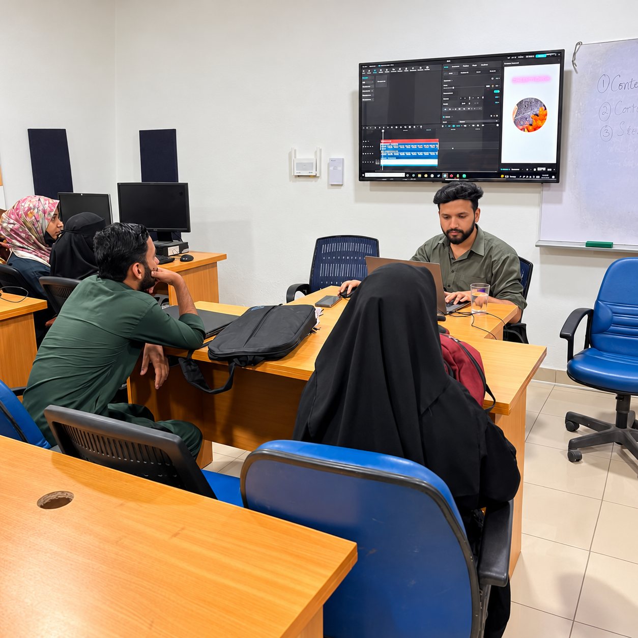 A mentor working with learners in an AI Sanctuary classroom